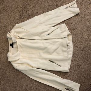cream colored jacket with zipper details